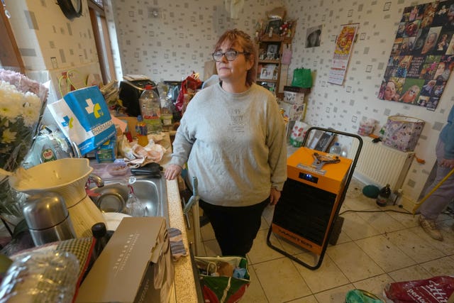 Elaine Byrne in her flooded home in Riverfield in Aughrim, County Wicklow (Brian Lawless/PA)