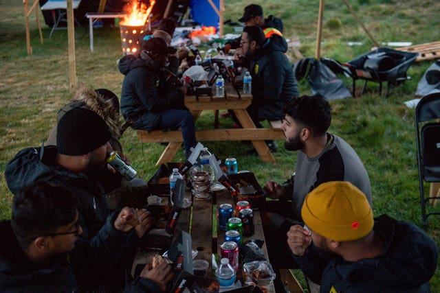 Members of Saltley Stallions Football Club eat together after fasting during Ramadan