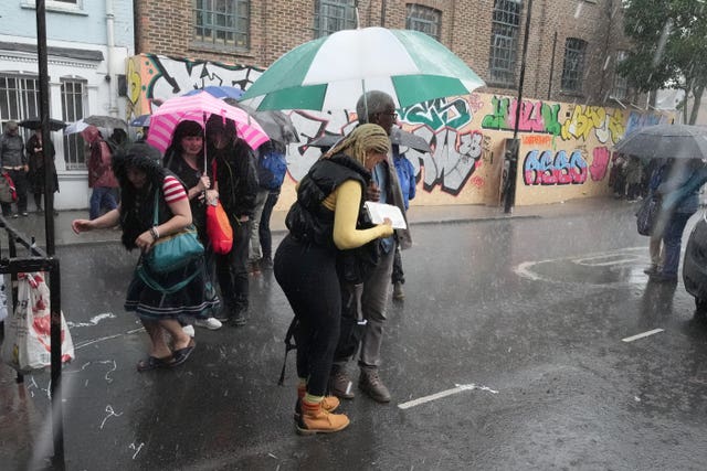 People sheltering from the rain in Notting Hill, west London. 