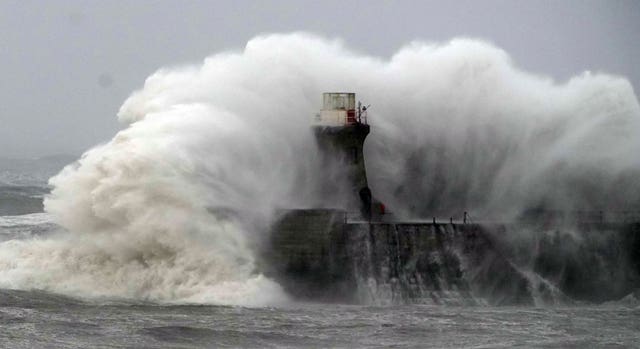 Waves crash against South Shields lighthouse 