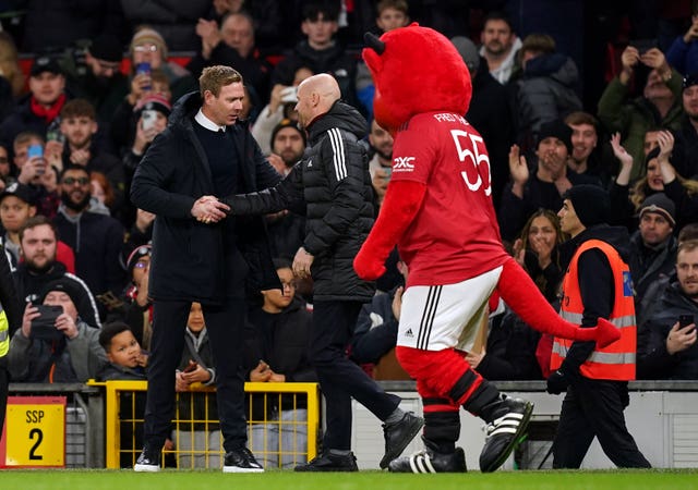 Charlton manager and United fan Dean Holden, left, shakes hands with Erik ten Hag in front of United mascot Fred the Red