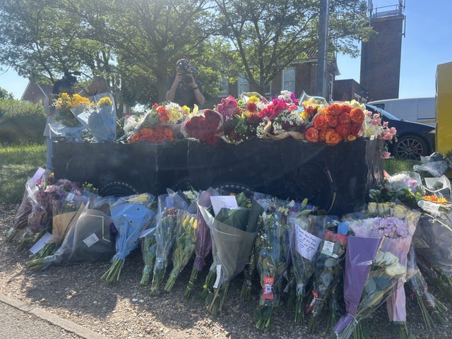 Floral tributes are seen outside Bicester Fire Station
