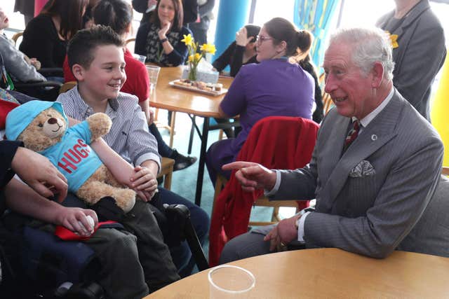 Charles meets a young boy during a visit to Ty Hafan children's hospice in Sully (Aaron Chown/PA)