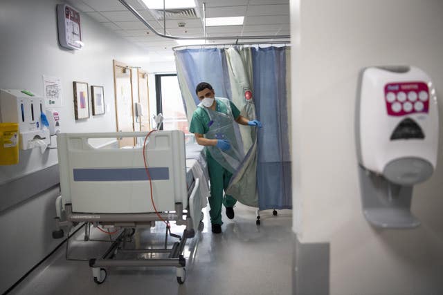 A staff nurse walks through the Acute Dependency Unit after taking food to a patient