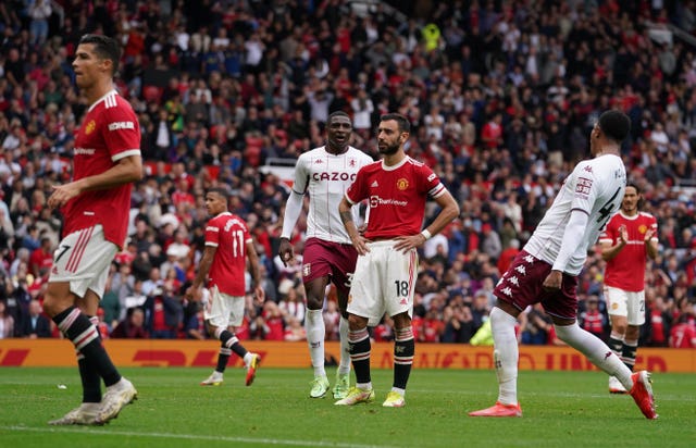 Bruno Fernandes, centre, reacts after missing a late penalty as Cristiano Ronaldo, left, looks on