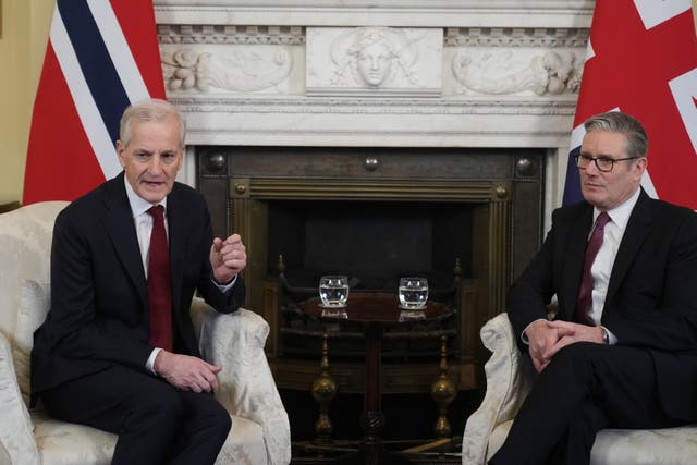 Sir Keir Starmer and Jonas Gahr Store sitting in chairs in front of UK and Norway flags inside Downing Street