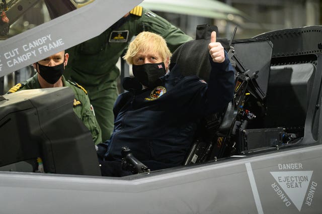 Prime Minister Boris Johnson sits in the cockpit of an Lockheed Martin F-35 Lightning II during his trip to Portsmouth on Friday
