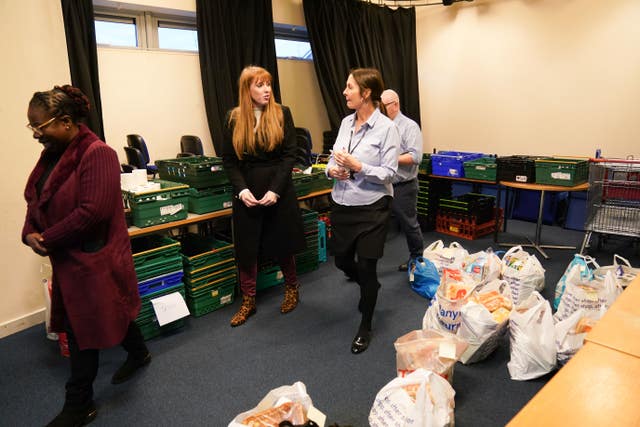 Ms Rayner, centre, and Ms Hamilton, left, talk to staff at a food bank in Castle Vale 