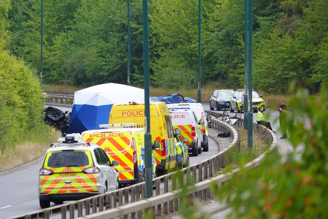 Police officers at the scene where the Passat and police car collided on the A66