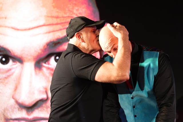 John Fury (left) kisses the head of son Tyson Fury during a press conference