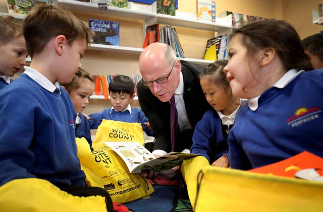 Education Secretary John Swinney with school pupils 
