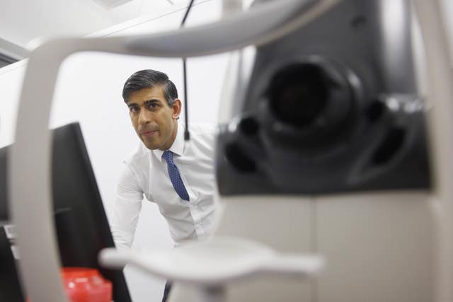 Prime Minister Rishi Sunak is shown a retinal scan procedure during a visit to Moorfields Eye Hospital in London