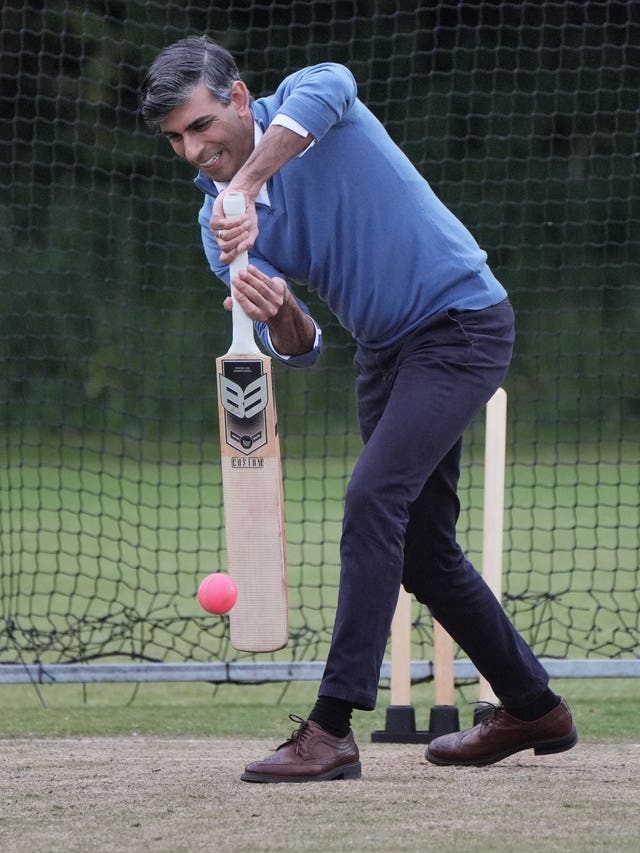 Rishi Sunak playing a forward defensive shot as he is bowled at during a cricket training session