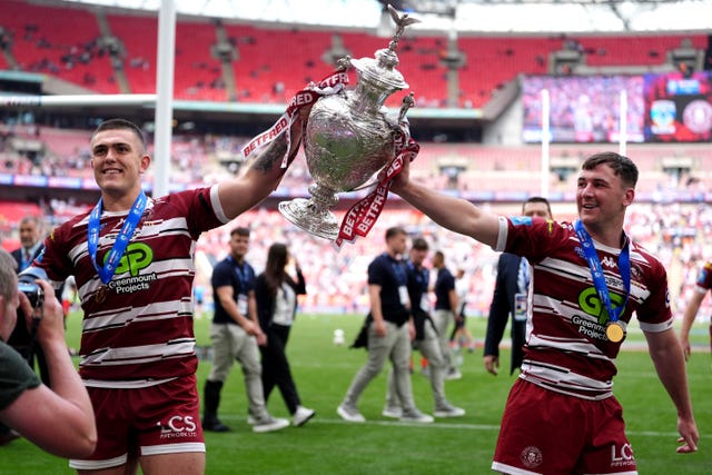 Wigan players lift the Challenge Cu[ as they celebrate at Wembley