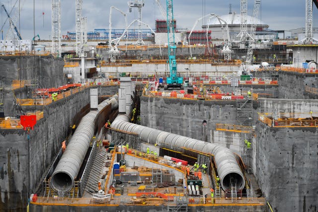 Workers construct reinforced steel around giant water cooling pipes during construction work at Hinkley Point C power station near Bridgwater, Somerset