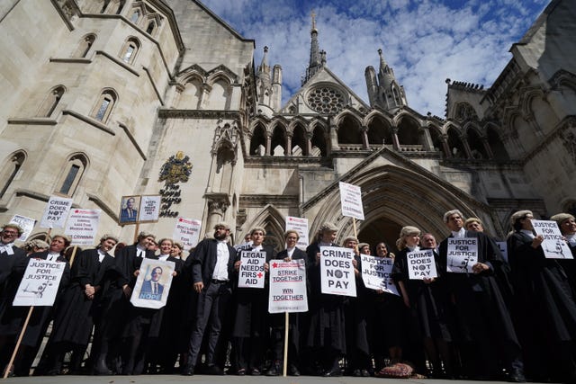Criminal defence barristers gather outside the Royal Courts of Justice in London to support the ongoing Criminal Bar Association action over Government-set fees for legal aid advocacy work