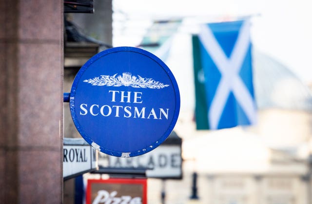 A sign showing The Scotsman newspaper masthead above a newsagent’s shop on North Bridge in Edinburgh