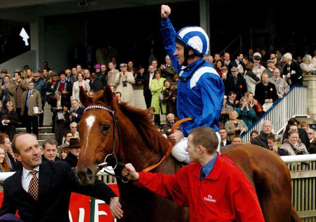 Richard Hills celebrates after riding Haafhd to victory in the Champion Stakes at Newmarket 