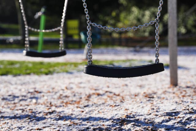 Playground swing covered in frost