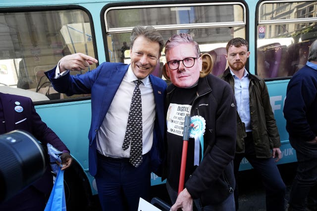 Reform UK deputy leader Richard Tice smiles and points at a person wearing a Sir Keir Starmer mask during a &lsquo;national fuel tax protest&rsquo; in Whitehall, central London