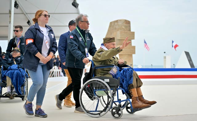 US Second World War veteran Andre C Chappaz waves as he arrives at the official international ceremony to mark the 80th anniversary of D-Day, at Omaha Beach in Saint-Laurent-sur-Mer, Normandy, France
