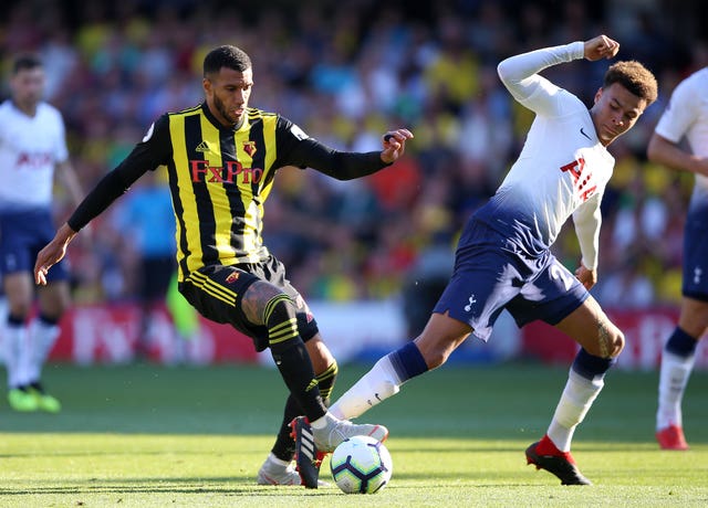Etienne Capoue (left) and Dele Alli battle for the ball