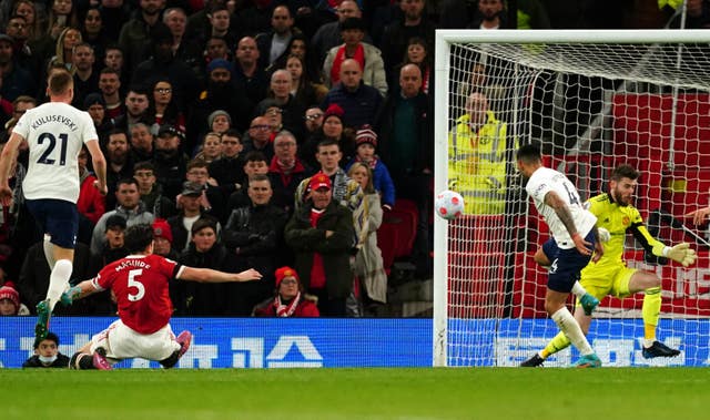 Manchester United captain Harry Maguire, second left, scores an own goal to level the scores against Tottenham