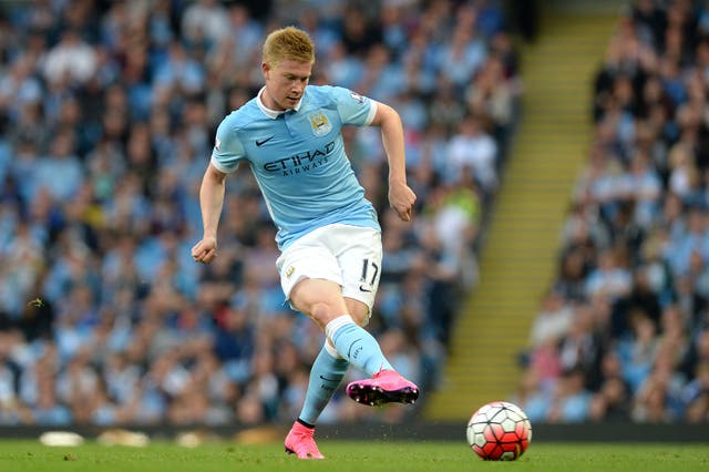 Kevin De Bruyne kicks a football while wearing Manchester City kit