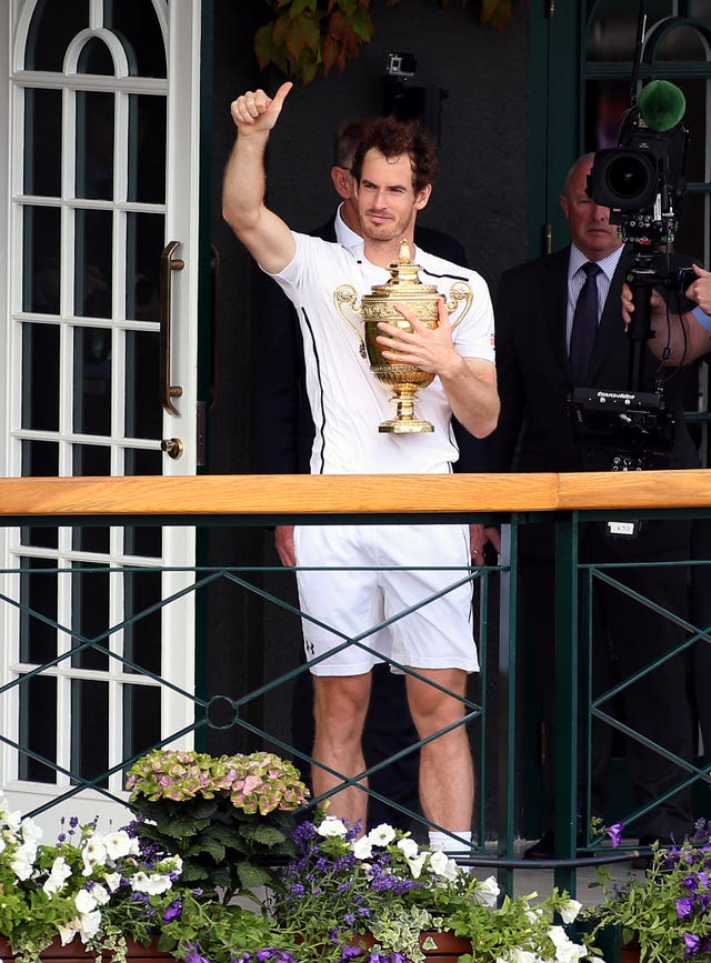 Sir Andy Murray parades the Wimbledon trophy on a centre court balcony (Steve Paston/PA)