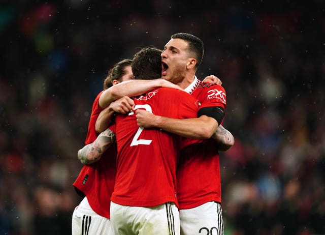 Manchester United’s Marcel Sabitzer, Victor Lindelof and Diogo Dalot celebrate their FA Cup semi-final shootout victory over Brighton on Sunday
