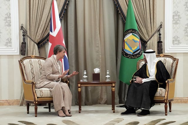 Yvette Cooper chats to Jasem Al Budaiwi, while seated next to each other