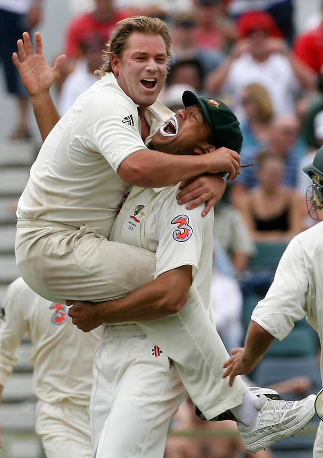 Australia’s Shane Warne (left) celebrates with Andrew Symonds after taking the final wicket of England’s Monty Panesar