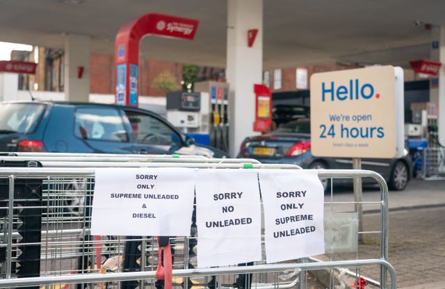 Signage indicating restricted availability of fuel at a petrol station in west London.