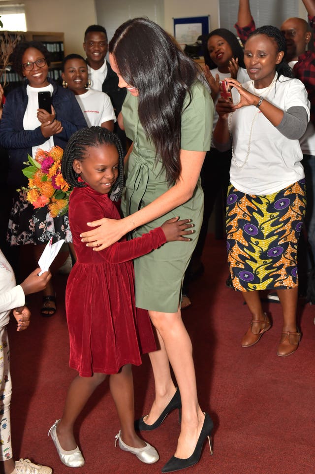 The duchess hugs eight-year-old Luyanda