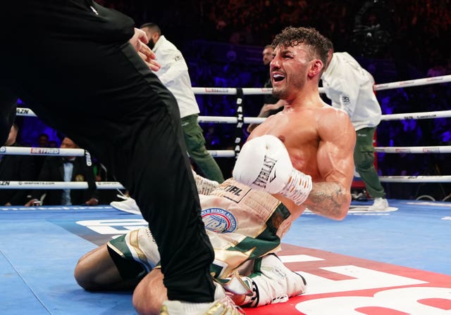Leigh Wood, on his knees, celebrates victory over Michael Conlan after their WBA Featherweight World Title contest