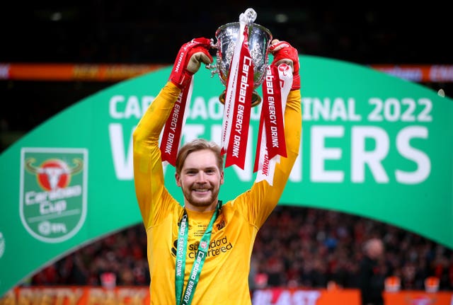Liverpool keeper Caoimhin Kelleher celebrates with the Carabao Cup after scoring the decisive penalty