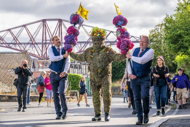 Burryman Andrew Taylor parades through the town of South Queensferry encased in burrs