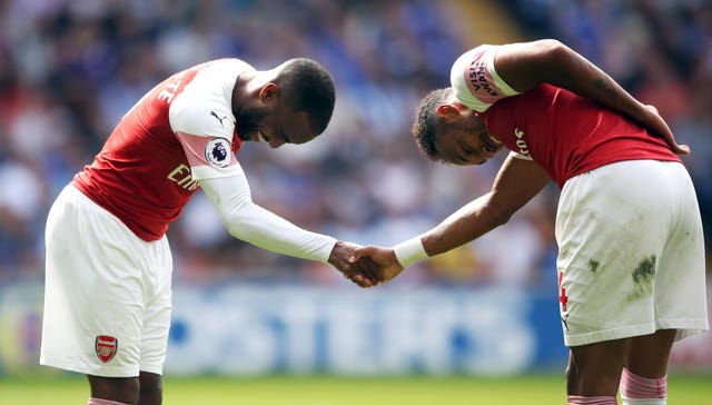 Lacazette (left) and Aubameyang (right) celebrate a goal during a tight win at Cardiff.