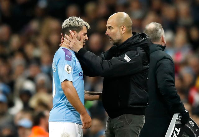 Sergio Aguero, left, appears in pain after being substituted against Chelsea on Saturday 