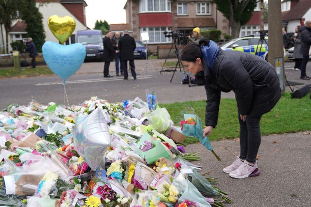 A woman lays flowers at the scene near Belfairs Methodist Church (Kirsty O'Connor/PA)