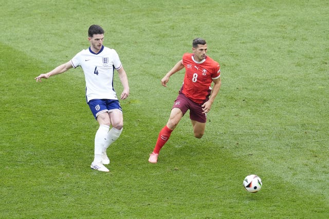 Declan Rice passes the ball during England's game against Switzerland 