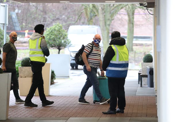 Travellers arrive at a quarantine hotel near Heathrow Airport