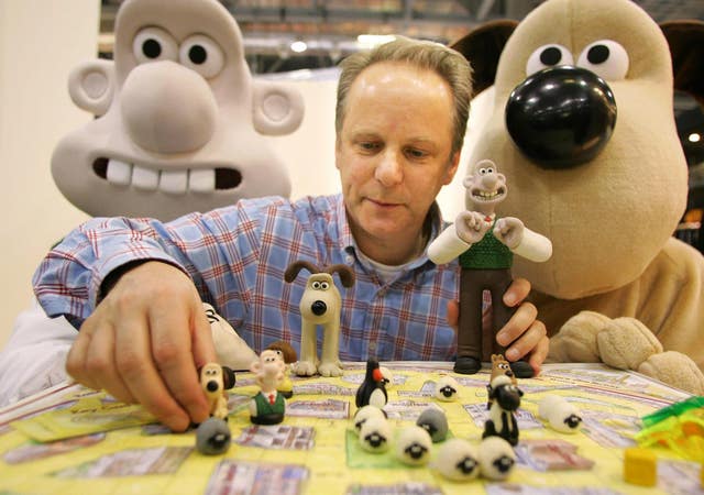 Nick Park with big and little Wallace and Gromit figures