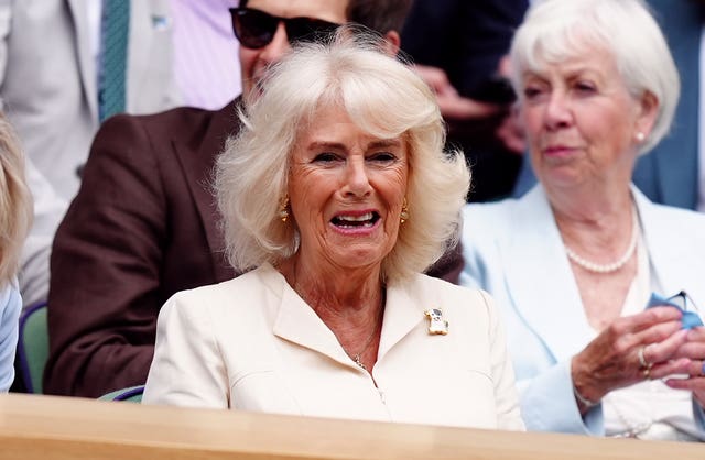 Camilla smiles as she sits in the royal box at Wimbledon 