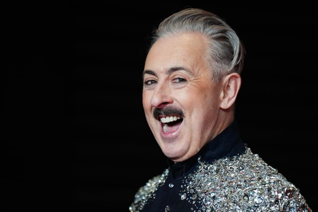 Alan Cumming laughing