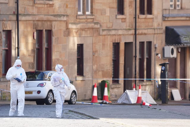 Two forensic officers on a street