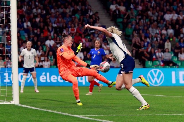 France goalkeeper Pauline Peyraud-Magnin, left, saves from Alessia Russo