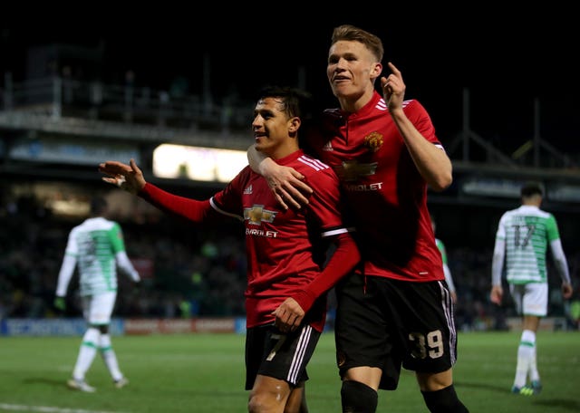 Alexis Sanchez (left) celebrates with Scott McTominay (right) after Ander Herrera scored Manchester United's second goal against Yeovil
