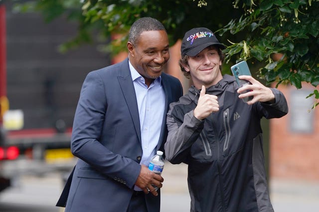 Paul Ince posing for a selfie with a fan outside court