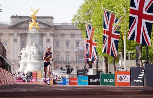 Eilish McColgan runs with Buckingham Palace in the background and Union flags